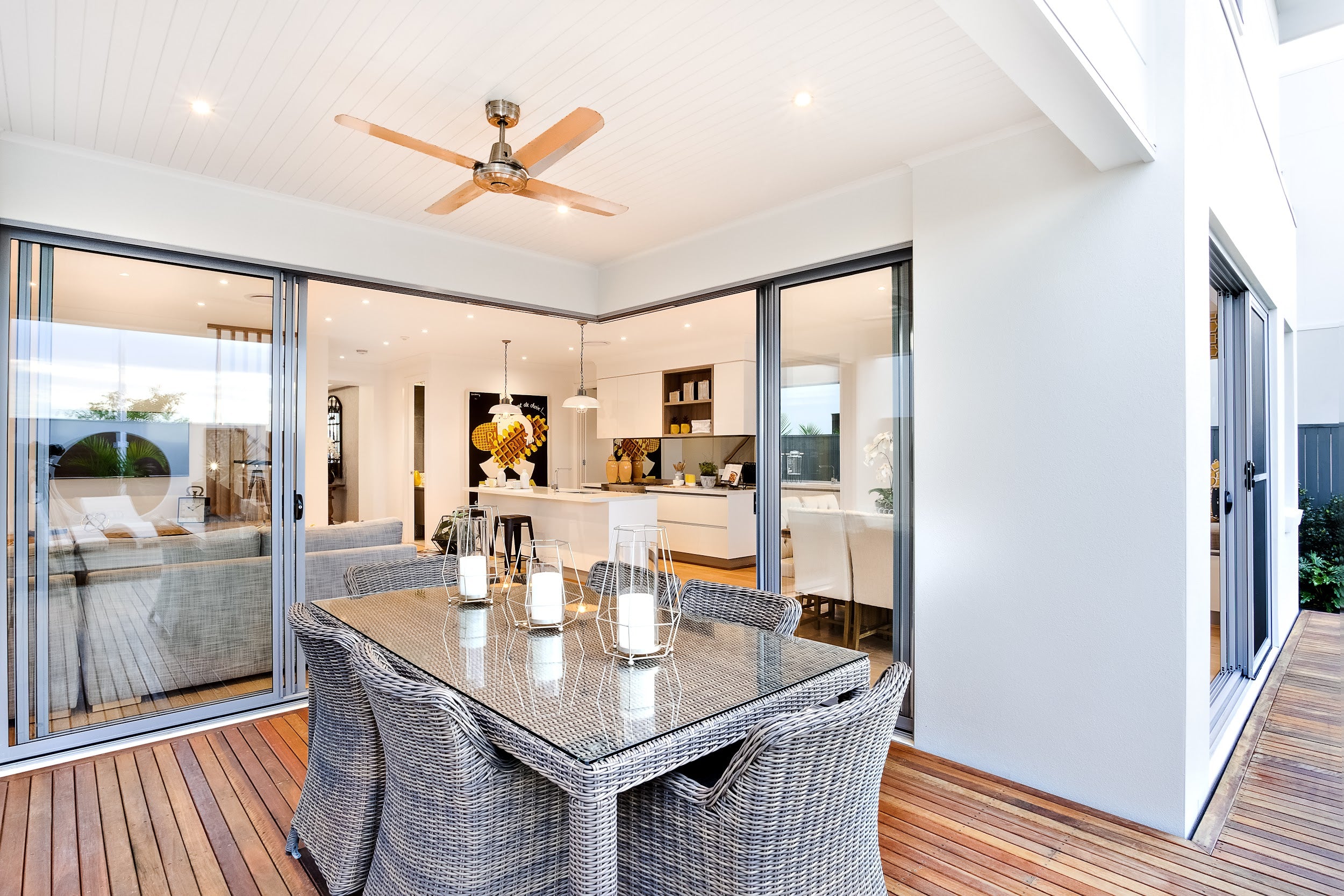 Outdoor patio area with candles on the table under the fan