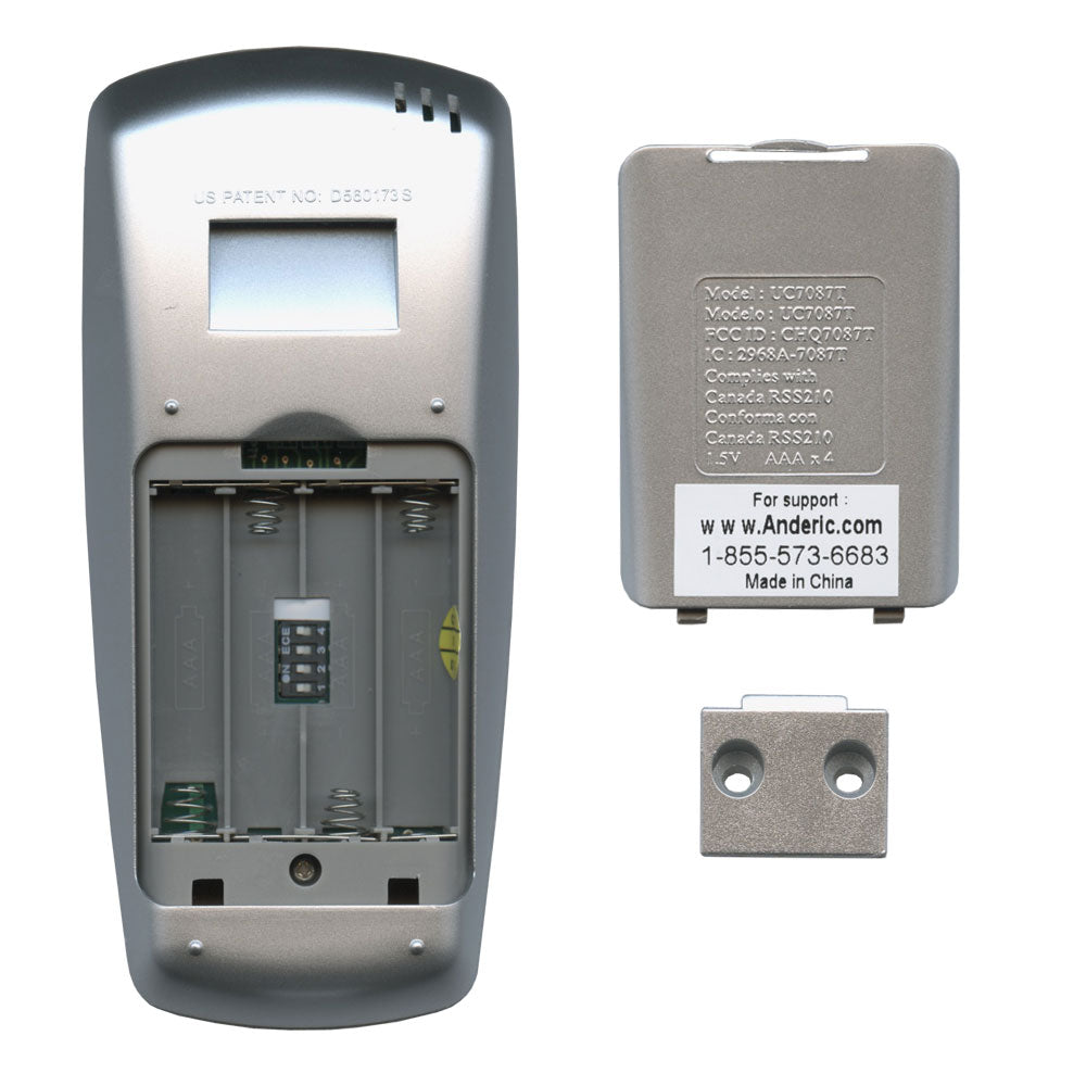 A silver Anderic UC7087T remote control for Hampton Bay ceiling fans is shown with the battery cover removed, exposing the compartment and missing batteries; the cover and mounting hardware are beside it. The support phone number is visible.